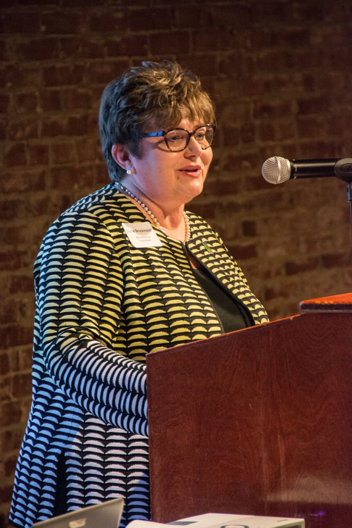 Diane Brockmeier, President and CEO of Mid-America Transplant speaks at the event